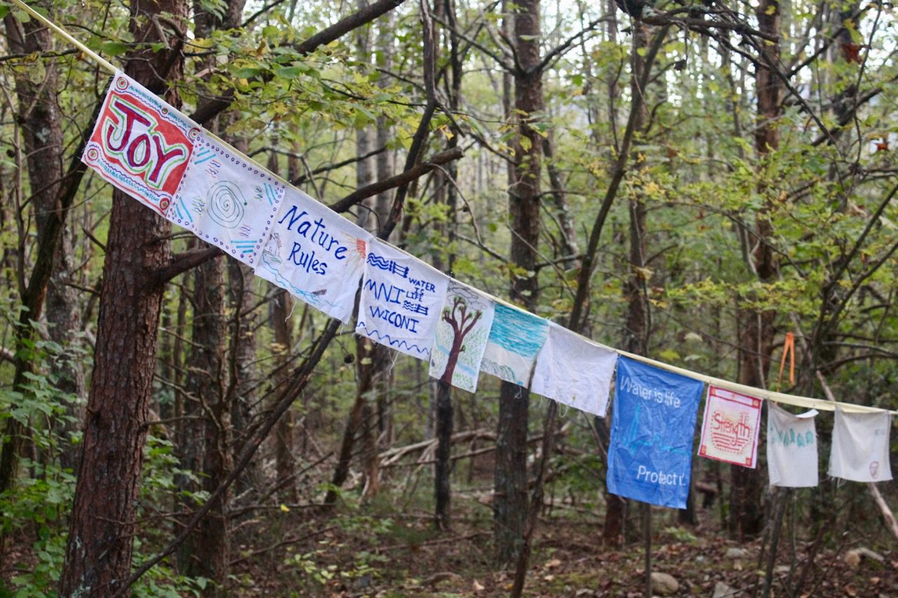 Prayer flags attached on a string, tied to trees at the campsite along the proposed pipeline route.